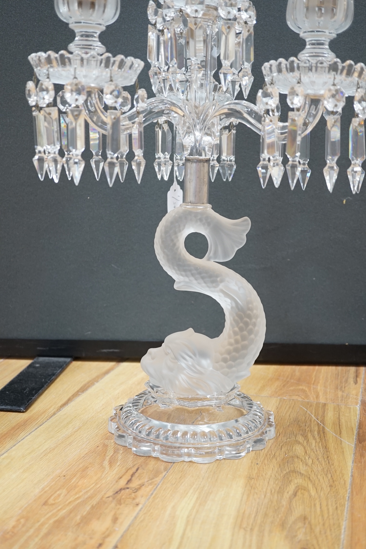 A Baccarat three branch, fish stemmed glass candelabra, 68cm high